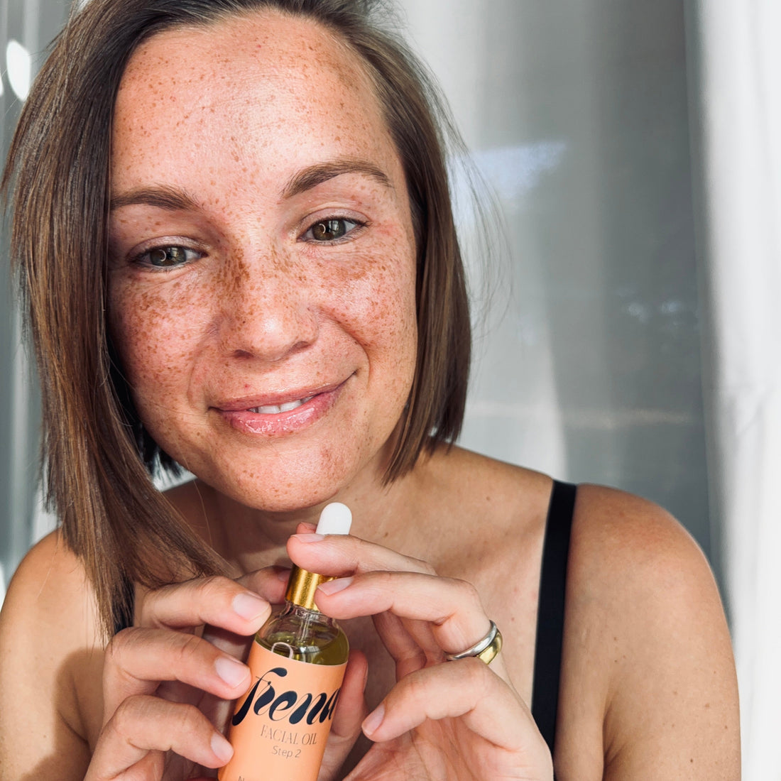 woman holding Facial Oil | Botanical Anti-Aging Blend with Rosehip & Black Raspberry Seed