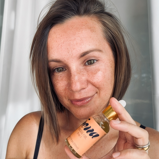 woman holding Facial Oil | Botanical Anti-Aging Blend with Rosehip & Black Raspberry Seed