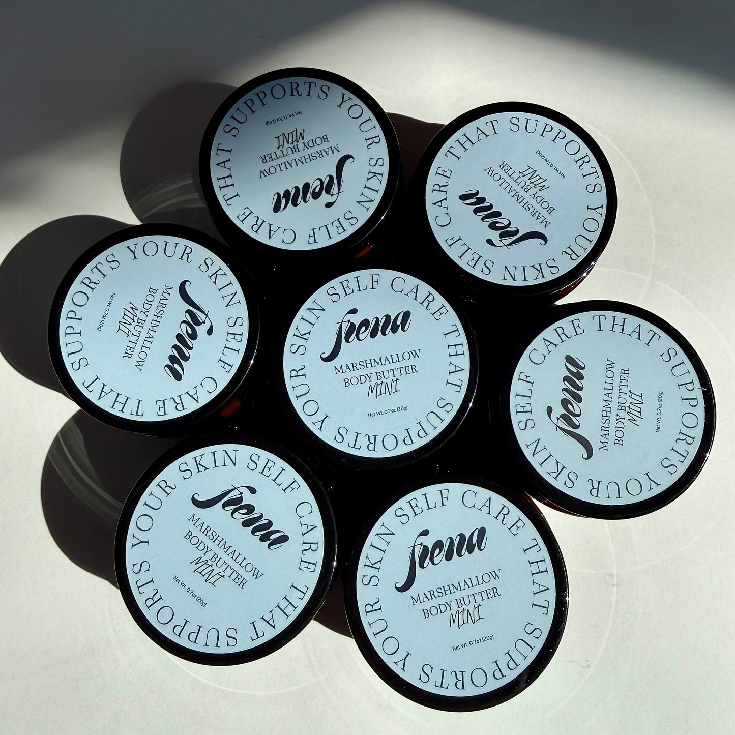 Marshmallow body butter in mini size. Several in a flower pattern. 