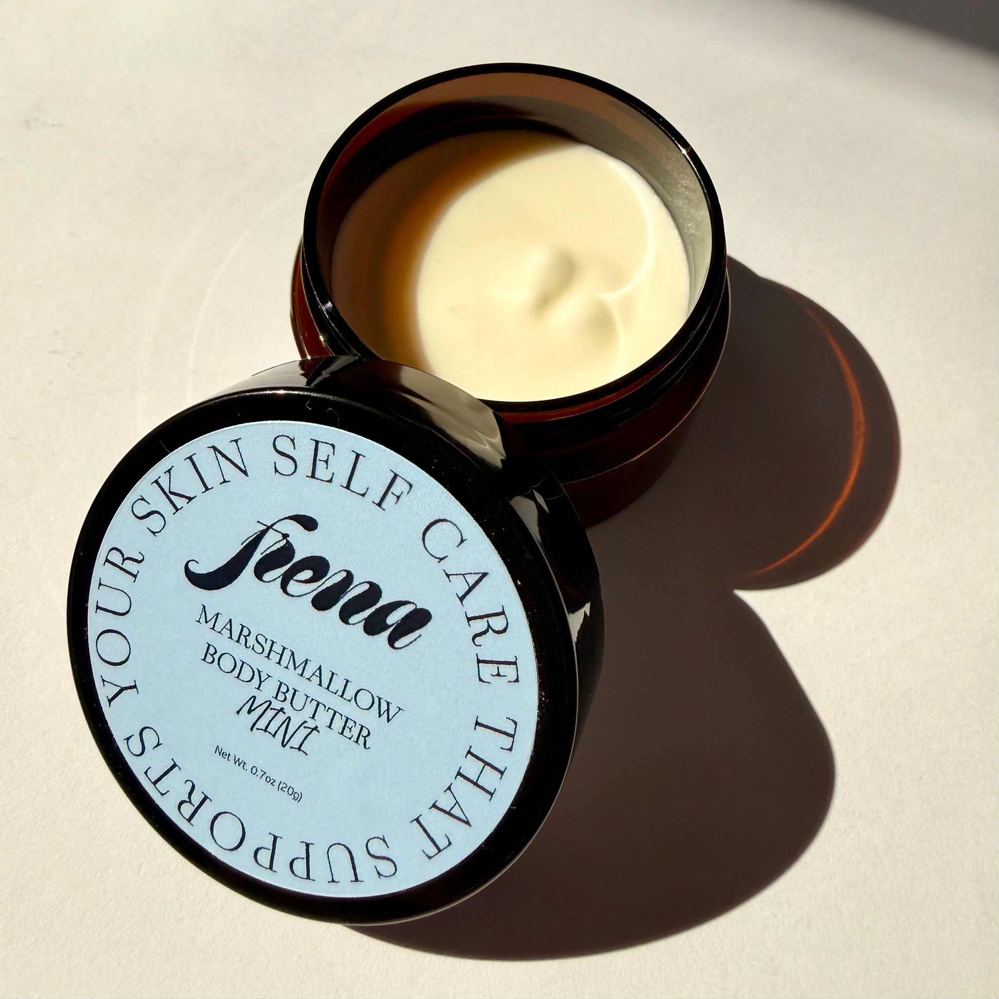 Marshmallow body butter in mini size with lid open