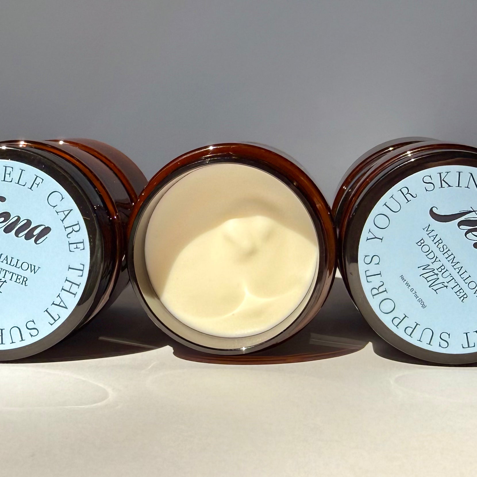 Marshmallow body butter in mini size with lid open